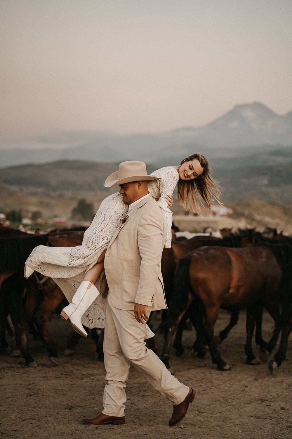 elopement couple walking among the wild horses in cappadocia